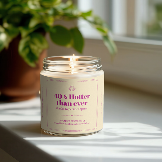 Sarcastic Candle in a glass jar with a label on a surface with a plant in the background